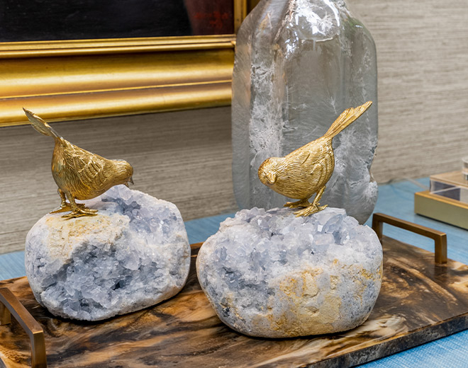 decorative rocks with bird statues on top