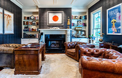 luxury room with couches and fireplace